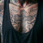 Man's chest covered in tattoos