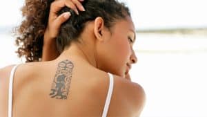 Young woman shows her tattoo