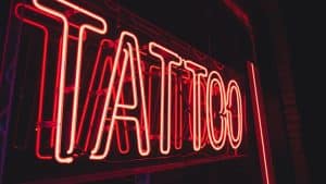 Neon sign spelling out the word tattoo
