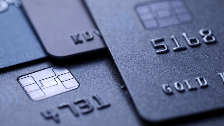 Black credit cards stacked on top of each other